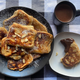 Plate of pancakes beside one serving on a plate dipped in chocolate